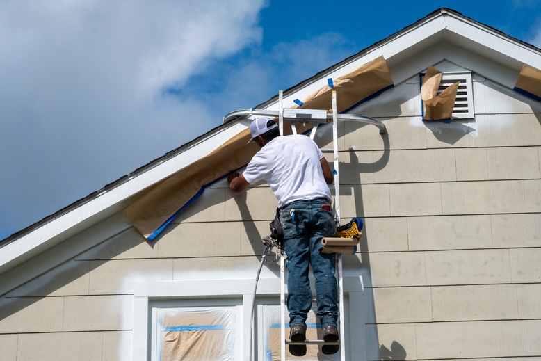 Professional exterior painting on a two-story home in Ann Arbor, MI
