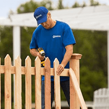 handyman installing a new fence for home