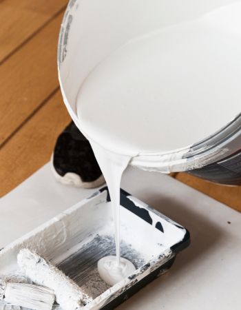 Pouring White Primer Paint Into Tray