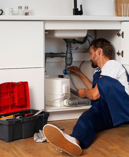 plumber fixing Kitchen sink