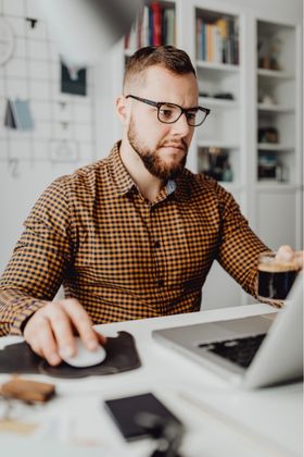 Man Working on Laptop from Home Office