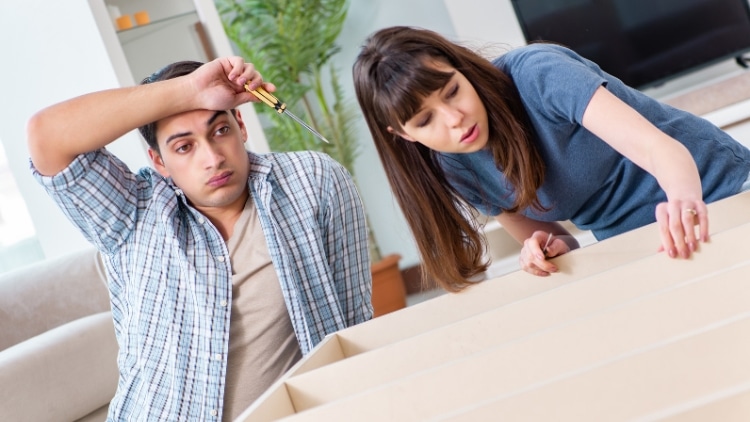 young family assembling furniture