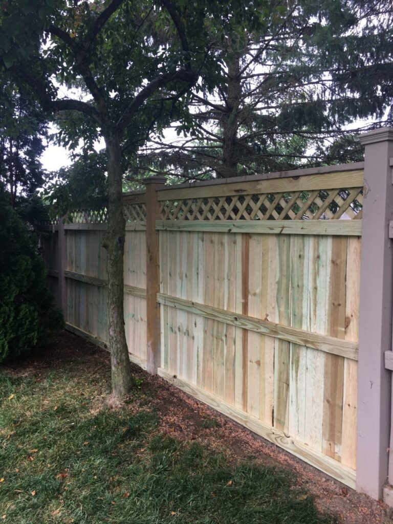 completed wooden fence installation job in Charleston, SC, with new lattice work installed for privacy