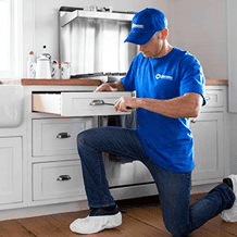 maintenance handyman repairing kitchen drawer