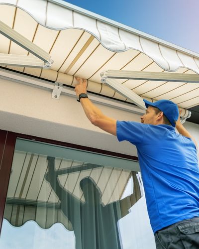 Worker install an awning