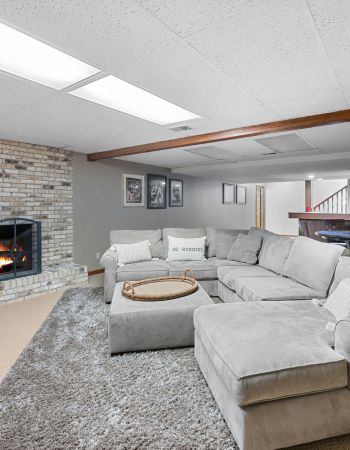 Modern Basement with Fireplace and Sectional Sofa