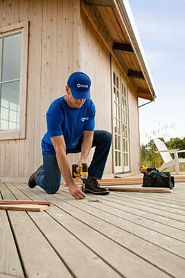 handyman from Handyman Connection installing new deck boards