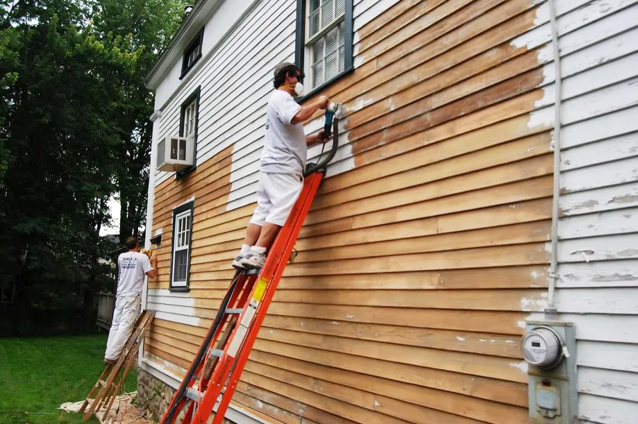 handymen painting the exterior of a house white