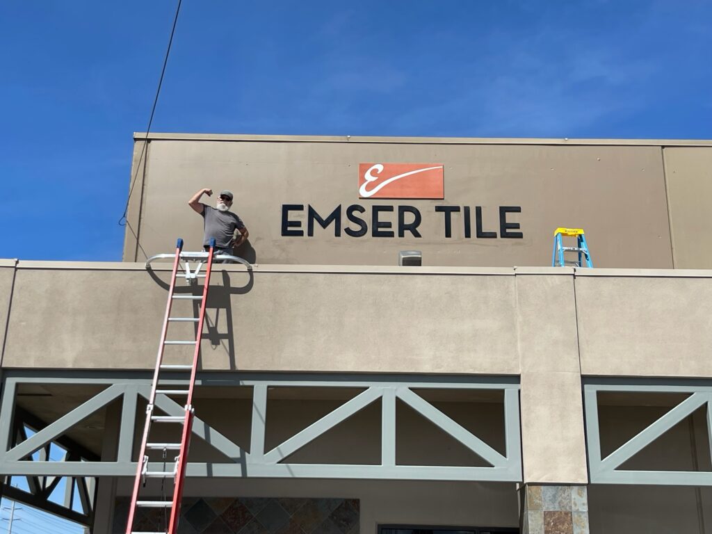 handyman installing business sign in Modesto, CA